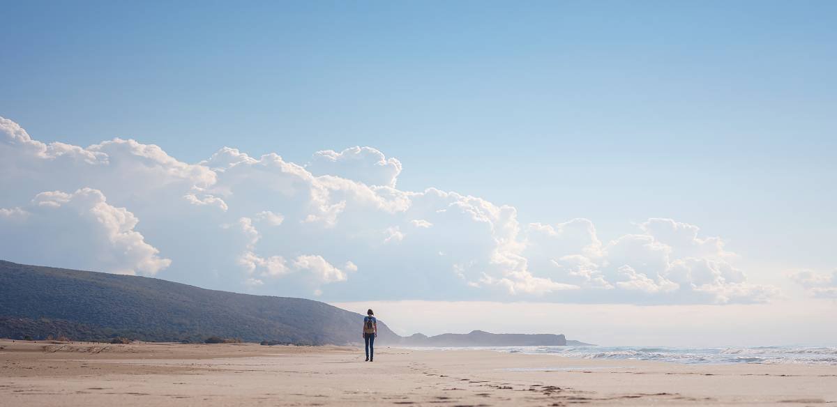 Make space for what you feel Lonely person walking on a beach
